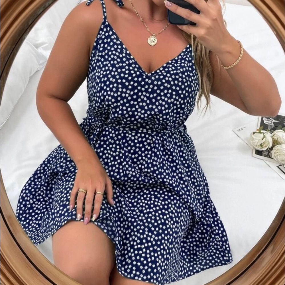 Navy blue cami dress with floral detail.